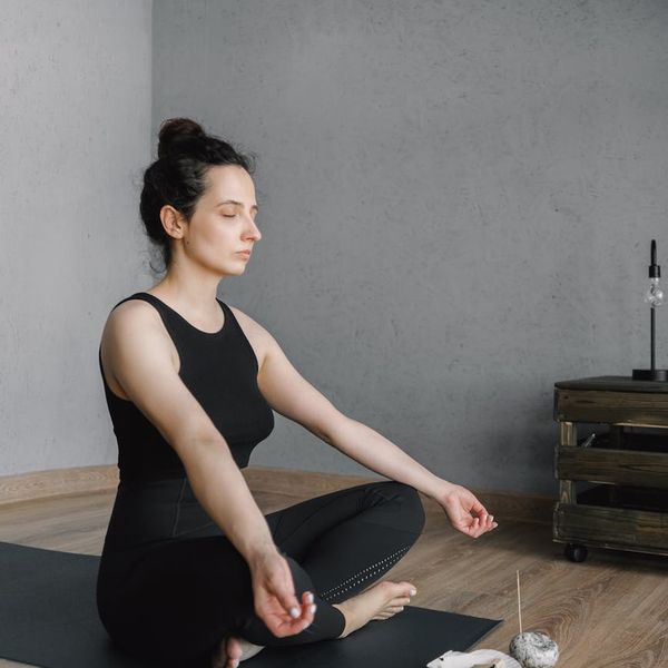 Woman meditating peacefully in a bright, modern space.